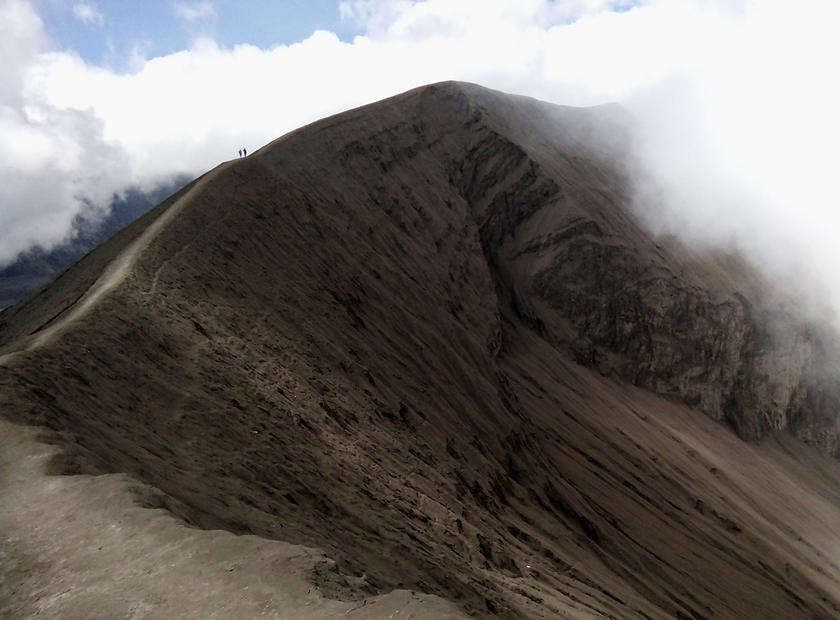 Bromo caldera cone is incandescent, rumbling, and smell of sulfur dioxide