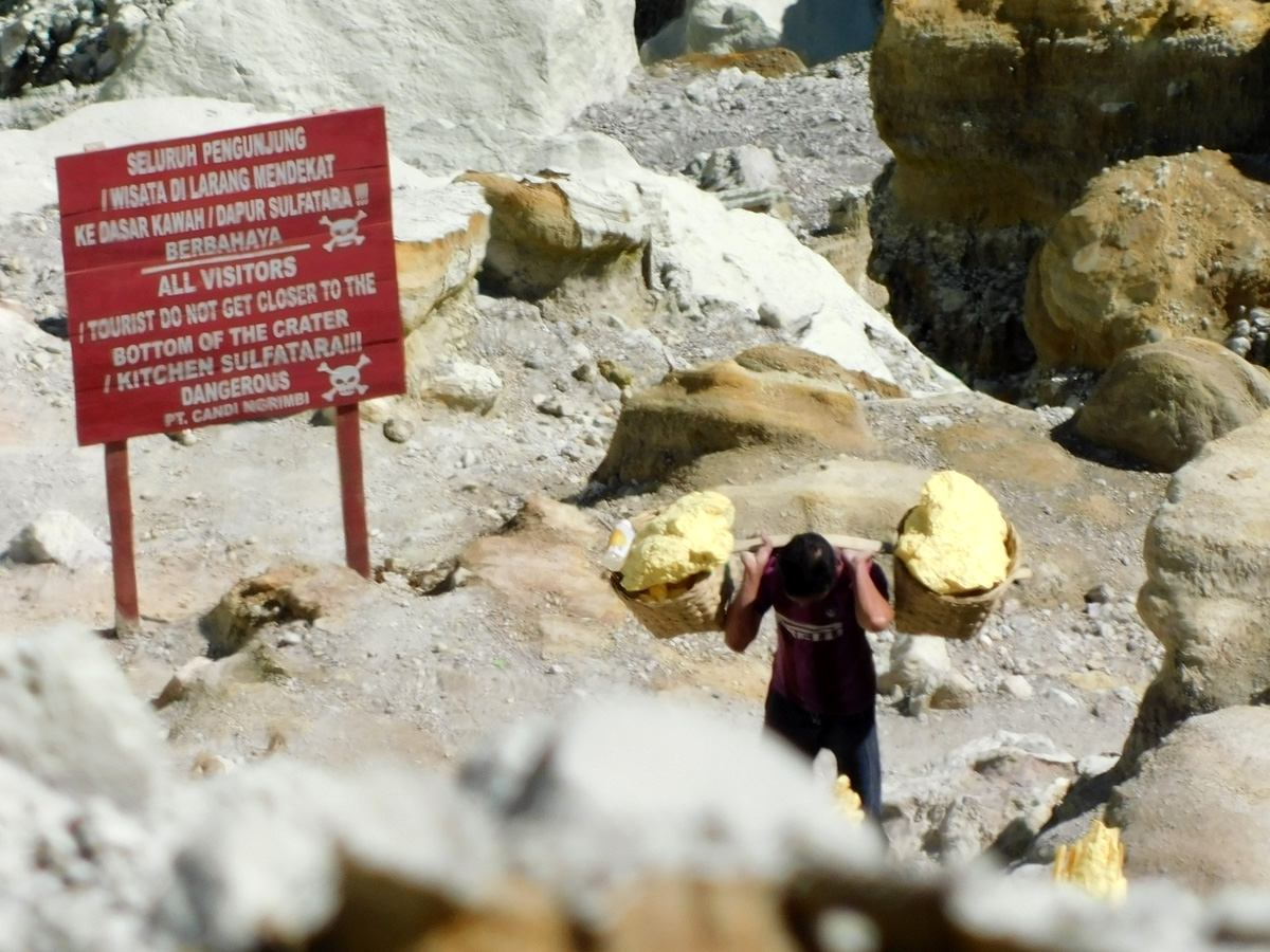 Daily struggle of a Ijen's quarryman with a fatigue of other times