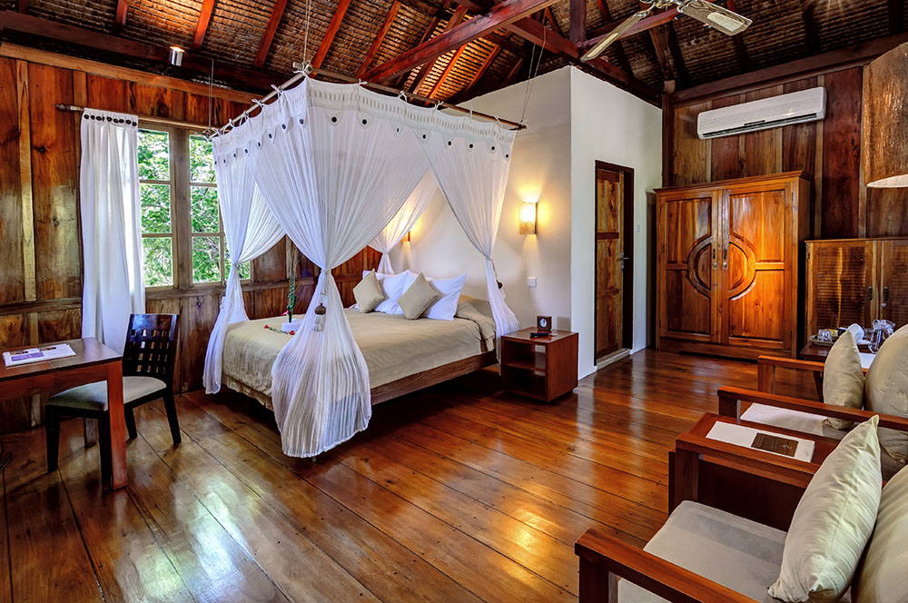 Palm Bungalow bedroom at Wakatobi Dive Resort